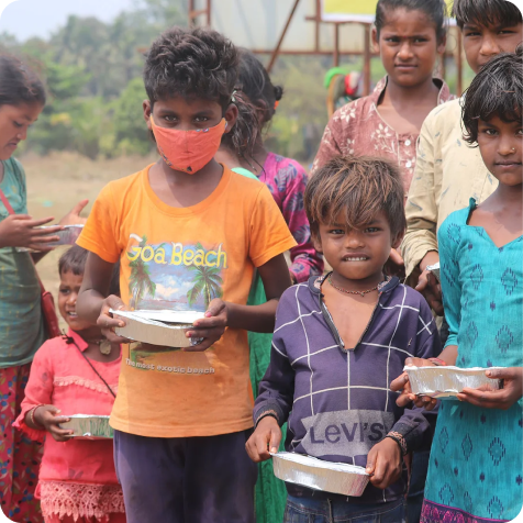 A child receiving a meal through El Shaddai Charitable Trust